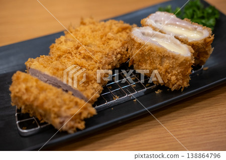 Tonkatsu, Fried Pork with cheese serve with cabbage on plate in restaurant 138864796