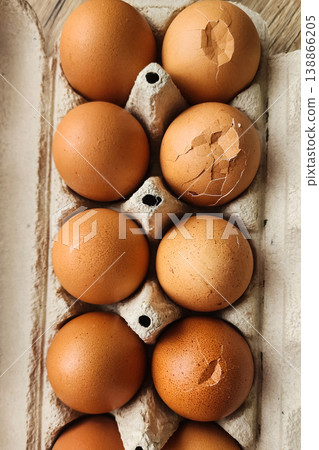 Brown eggs in carton with cracked shells Brown eggs in carton with cracked shells 138866205