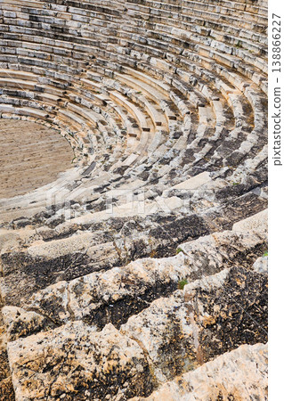 Ancient greek theater ruins showing marble seating Ancient greek theater ruins showing marble seating 138866227