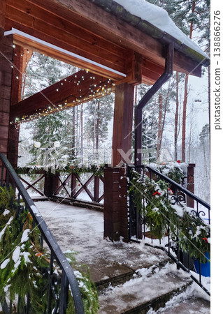 Wooden building decorated for winter holidays with snow 138866276