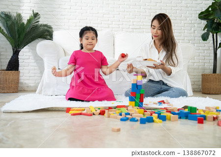 Cherry young mother plays colorful toy block with her Down syndrome daughter, colorful wooden toys can increase skills and learning to increase the development, special education, Knowing slowly Cherry young mother plays colorful toy block with her Down syndrome daughter, colorful wooden toys can increase skills and learning to increase the development, special education, Knowing slowly 138867072