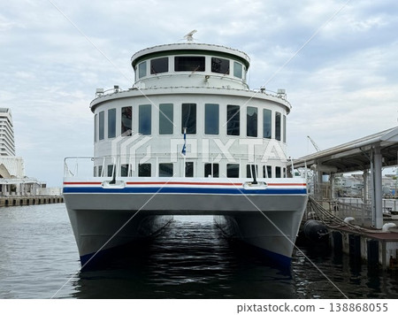 A catamaran, characterized by its high stability and resistance to rolling, which is moored in the harbor. A catamaran, characterized by its high stability and resistance to rolling, which is moored in the harbor. 138868055