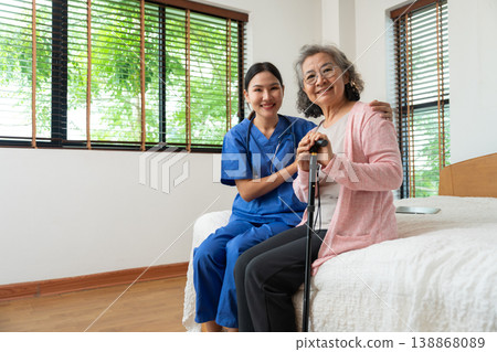 An elderly individual receives compassionate care from a healthcare professional in a cozy home setting. Their warm interaction highlights trust, support, importance of personalized medical attention 138868089