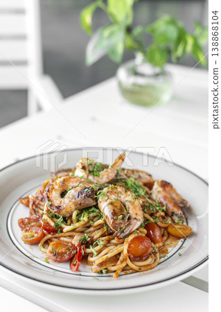 shrimp and tomato diavolo spicy spaghetti on white table at outdoor restaurant in italy shrimp and tomato diavolo spicy spaghetti on white table at outdoor restaurant in italy 138868104
