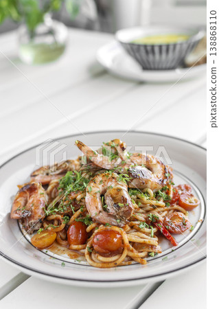 shrimp and tomato diavolo spicy spaghetti on white table at outdoor restaurant in italy shrimp and tomato diavolo spicy spaghetti on white table at outdoor restaurant in italy 138868110