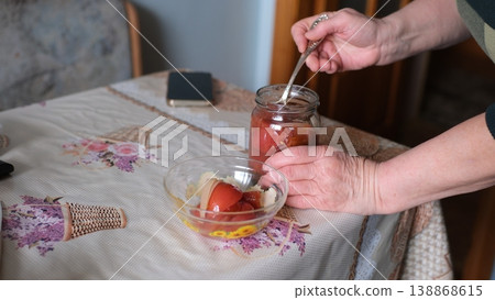 Opening jar pickled tomatoes winter preserves glass jar homemade food female hands closeup Opening jar pickled tomatoes winter preserves glass jar homemade food female hands closeup 138868615