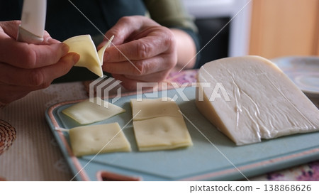 Cheese serving sliced packaged cheese sheep cheese calcium rich dairy home kitchen closeup 138868626