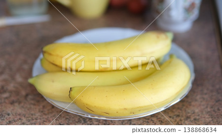 Fresh ripe bananas on white plate healthy nutrition natural fruit closeup yellow bananas Fresh ripe bananas on white plate healthy nutrition natural fruit closeup yellow bananas 138868634