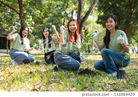Green Team Planting Trees: A cheerful group of volunteers plants saplings in a sunny park, fostering a sense of community, teamwork, and environmental stewardship, symbolizing growth and renewal. Green Team Planting Trees: A cheerful group of volunteers plants saplings in a sunny park, fostering a sense of community, teamwork, and environmental stewardship, symbolizing growth and renewal. 138869420