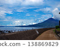 A coastline overlooking the blue sky and Sakurajima volcano. 138869829