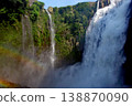 A landscape with a waterfall and a rainbow 138870090