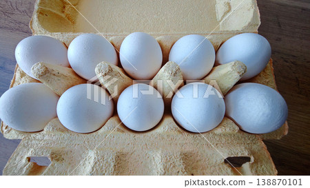 Ten white eggs arranged in a carton for cooking or baking in the kitchen Ten white eggs arranged in a carton for cooking or baking in the kitchen 138870101