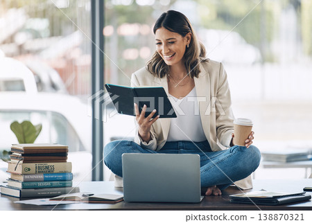 Business woman, laptop or reading notebook while sitting on desk in marketing office, advertising company or creative startup. Smile, happy or relax worker with books, technology or innovation vision 138870321