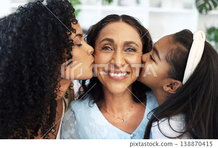 Portrait, kiss on the cheek for a senior woman with her daughter and granddaughter in their home together. Face, love or family with a mother, adult child and girl bonding in a house on mothers day 138870415
