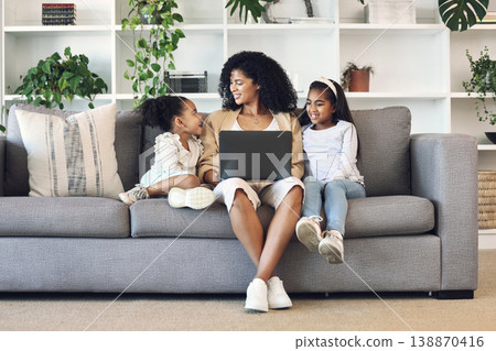 Mother, children and laptop in family home living room for remote work, online education and wifi. Woman and girl kids together on couch with internet for learning, games and watch movies or relax 138870416