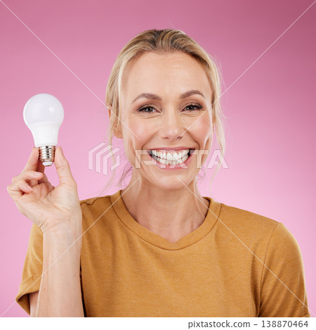 Lightbulb, portrait and woman isolated on pink background for beauty ideas, inspiration or cosmetics solution. Happy model or mature person with light bulb thinking of dermatology, skincare or health Lightbulb, portrait and woman isolated on pink background for beauty ideas, inspiration or cosmetics solution. Happy model or mature person with light bulb thinking of dermatology, skincare or health 138870464