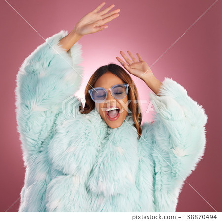 Fashion and dance with woman in fur coat in studio for glamour, elegant and trendy style. Happy, natural and confidence with female dancing on pink background for classy, music and winter Fashion and dance with woman in fur coat in studio for glamour, elegant and trendy style. Happy, natural and confidence with female dancing on pink background for classy, music and winter 138870494