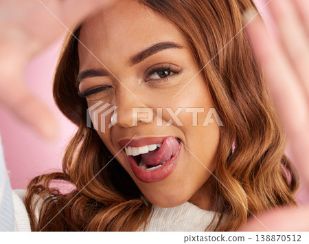 Wink, selfie and portrait of woman with tongue out in studio, happy and flirting while posing. Face, emoji and girl makeup or beauty influencer with gesture for photo, profile picture or blog pose Wink, selfie and portrait of woman with tongue out in studio, happy and flirting while posing. Face, emoji and girl makeup or beauty influencer with gesture for photo, profile picture or blog pose 138870512