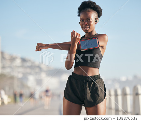 Portrait, music and stretching with a sports black woman outdoor on a blurred background for cardio or endurance training. Exercise, health or phone with a young runner getting ready for a workout Portrait, music and stretching with a sports black woman outdoor on a blurred background for cardio or endurance training. Exercise, health or phone with a young runner getting ready for a workout 138870532