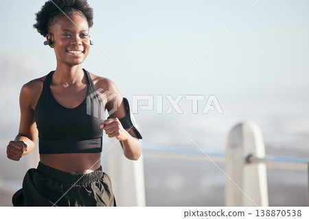 Smile, running and black woman outdoor with music earphones for radio, podcast and mockup space. Sports, fitness and happy African athlete training, workout or exercise for health, wellness or cardio 138870538