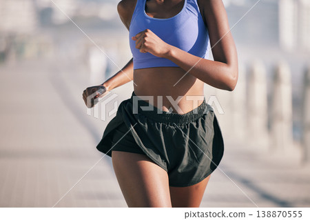 Closeup, sports woman and running motion in sunshine for marathon race, performance and fitness. Female runner, cardio training and summer workout for energy, fast action and power of urban exercise Closeup, sports woman and running motion in sunshine for marathon race, performance and fitness. Female runner, cardio training and summer workout for energy, fast action and power of urban exercise 138870555