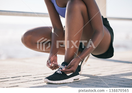 Hands, city and runner tie shoes to start workout, training or exercise outdoor. Sports, fitness and athlete tying laces on sneakers to prepare for cardio, running and jog for body health or wellness 138870565