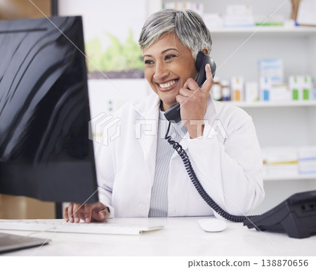 Pharmacist, telephone and computer for prescription with woman in conversation for retail healthcare. Chemist, working and pharmacy on computer with customer service or medicine with telehealth. 138870656
