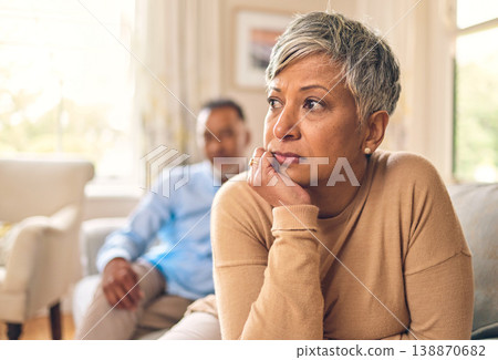Divorce, fight and mature woman is sad in living room with partner at home with depression or thinking. Conflict, wife and marriage with infidelity is upset on sofa with couple, cheating, frustrated. Divorce, fight and mature woman is sad in living room with partner at home with depression or thinking. Conflict, wife and marriage with infidelity is upset on sofa with couple, cheating, frustrated. 138870682