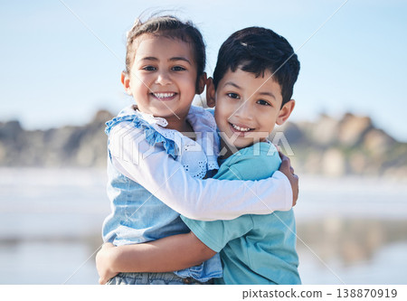 Portrait, brother and girl in hug on the beach as children on holiday or vacation during family summer on a blurred background. Smile, love and siblings with kids bonding outdoor in nature together 138870919