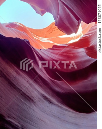 The blue sky peeks through the fantastical Lower Antelope Canyon. 138871065