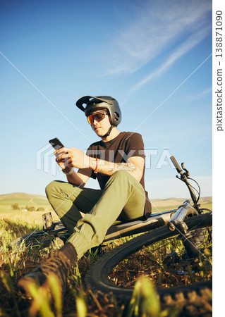 Mountain bike, phone and man outdoor in nature for extreme sports, training or workout. Smartphone, online communication and male person with bicycle for off road cycling, travel or adventure Mountain bike, phone and man outdoor in nature for extreme sports, training or workout. Smartphone, online communication and male person with bicycle for off road cycling, travel or adventure 138871090