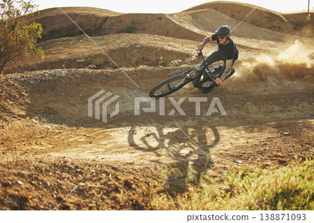 Dust, mountain bike and man outdoor in nature for extreme sports, training or workout. Downhill, fitness and male person with courage or bicycle stunt for off road cycling, travel or adventure 138871093