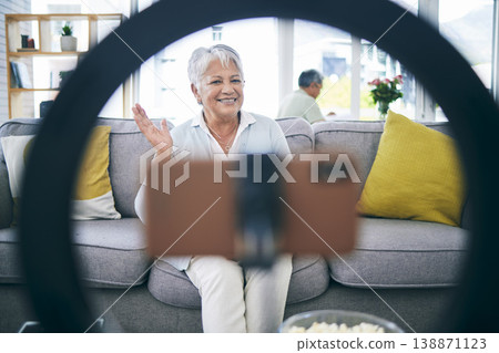 Mature woman, live streaming and vlog in home for social media, chat broadcast or wave to audience online. Happy lady, content creator and filming digital podcast in living room, phone and ring light Mature woman, live streaming and vlog in home for social media, chat broadcast or wave to audience online. Happy lady, content creator and filming digital podcast in living room, phone and ring light 138871123