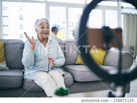 Mature woman, live stream and broadcast in home on social media, online vlog or communication to virtual audience. Lady, content creator or filming digital podcast in lounge with phone, light or blog Mature woman, live stream and broadcast in home on social media, online vlog or communication to virtual audience. Lady, content creator or filming digital podcast in lounge with phone, light or blog 138871128