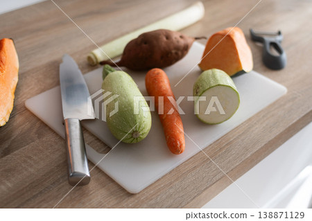 Fresh vegetables on cutting board with zucchini carrot potato and pumpkin Fresh vegetables on cutting board with zucchini carrot potato and pumpkin 138871129