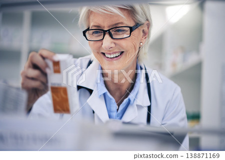 Happy woman, pharmacist and reading medication on shelf for inventory, diagnosis or prescription at pharmacy. Mature female person, medical or healthcare professional checking medicine in drugstore Happy woman, pharmacist and reading medication on shelf for inventory, diagnosis or prescription at pharmacy. Mature female person, medical or healthcare professional checking medicine in drugstore 138871169