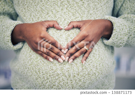 Pregnancy, closeup and woman with a heart shape on her maternal belly for care and motherhood. Health, zoom and African pregnant female person hands on stomach with a love sign or emoji for her baby. 138871173