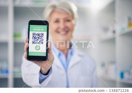 Woman, pharmacist and phone with QR code scan for covid certification or verification at pharmacy. Hands of female person, medical or healthcare professional show mobile smartphone app for approval Woman, pharmacist and phone with QR code scan for covid certification or verification at pharmacy. Hands of female person, medical or healthcare professional show mobile smartphone app for approval 138871226