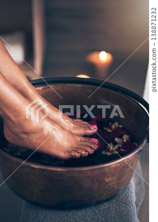 Spa, health and woman feet in water to soak with flowers for a luxury, glamour and pedicure treatment. Wellness, beauty and closeup of female person relaxing for a zen self care routine at calm salon Spa, health and woman feet in water to soak with flowers for a luxury, glamour and pedicure treatment. Wellness, beauty and closeup of female person relaxing for a zen self care routine at calm salon 138871232