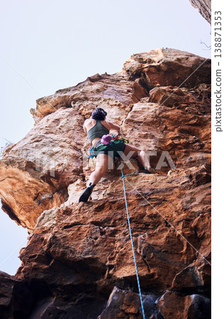 Rock climbing, travel and mountains with woman in nature for sports, explore and adventure. Health, exercise and fitness with person training on cliff for rope, challenge and performance Rock climbing, travel and mountains with woman in nature for sports, explore and adventure. Health, exercise and fitness with person training on cliff for rope, challenge and performance 138871353