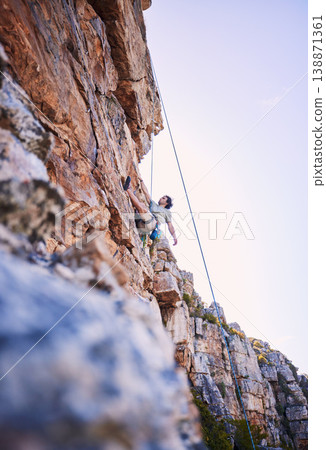 Rock climbing, fitness and sports with man in nature for mountains, explore and adventure. Health, exercise and travel with person training on cliff for rope, challenge and performance mockup 138871361
