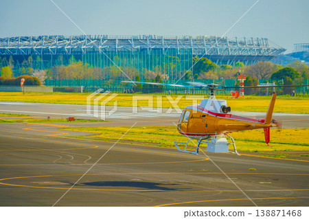Ground crew and a parked helicopter Ground crew and a parked helicopter 138871468