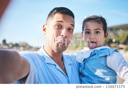 Father, daughter and funny face in beach selfie, portrait or memory together in summer, vacation or outdoor. Man, young girl kid and comic for photography, profile picture or holiday on social media 138871575