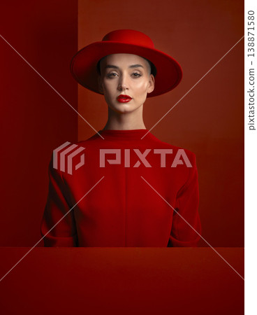 Portrait, reverse fashion and mockup with a woman on a red background in studio for marketing, advertising or branding. Luxury, aesthetic style or trendy young female model standing with empty space Portrait, reverse fashion and mockup with a woman on a red background in studio for marketing, advertising or branding. Luxury, aesthetic style or trendy young female model standing with empty space 138871580