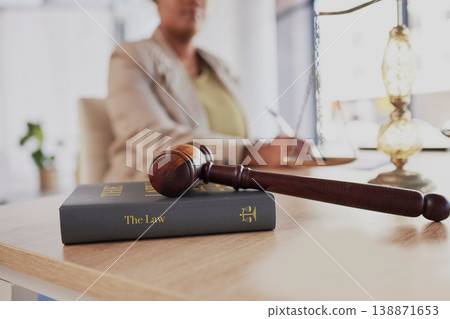 Gavel, law firm and books on table of attorney in office for judge, justice and court trial. Closeup of advocate, lawyer and worker with hammer, research and legal notebook at desk for constitution 138871653