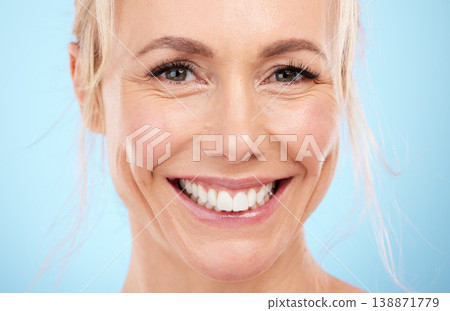 Portrait, old woman and skincare with cosmetics, happiness and dermatology against blue studio background. Face detox, mature female and senior lady with organic facial, smile or wellness on backdrop 138871779