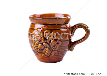 Vintage glazed ceramic mug produced by the famous Vasylkiv pottery plant, featuring traditional Ukrainian floral ornament and warm brown tones, isolated on white background. 138872213