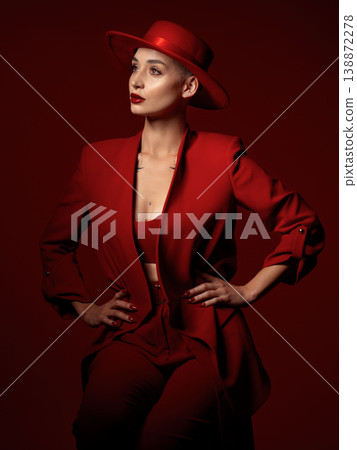 Vision, fashion and a woman thinking on a red studio background for elegant or trendy style. Aesthetic, future and beauty with a young female model standing hands on hips while looking edgy or classy Vision, fashion and a woman thinking on a red studio background for elegant or trendy style. Aesthetic, future and beauty with a young female model standing hands on hips while looking edgy or classy 138872278