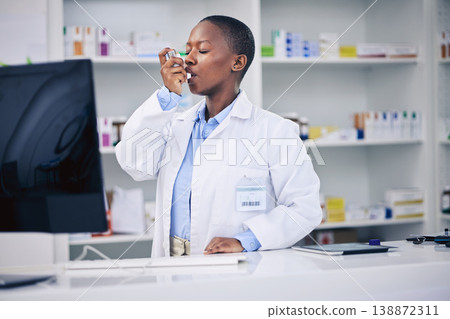 Black woman, pharmacist and asthma inhaler for relief, breathing or cure at the pharmacy. Calm African female person in medical healthcare with chest pain, lungs or allergy taking deep breath in pump 138872311