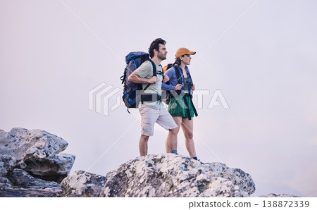 Mountains, hiking and man with woman on cliff for adventure in nature, landscape and travel. Outdoor trekking, couple on peak and relax in scenic clouds for natural journey, walking and rock climbing 138872339